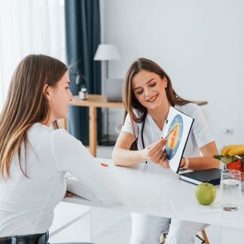 woman-showing-illustration-to-the-female-customer-resize.jpg